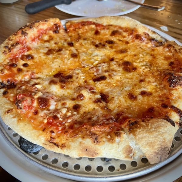 A whole cheese pizza from Scordato's Pizzeria, with a crispy crust and melted golden cheese.